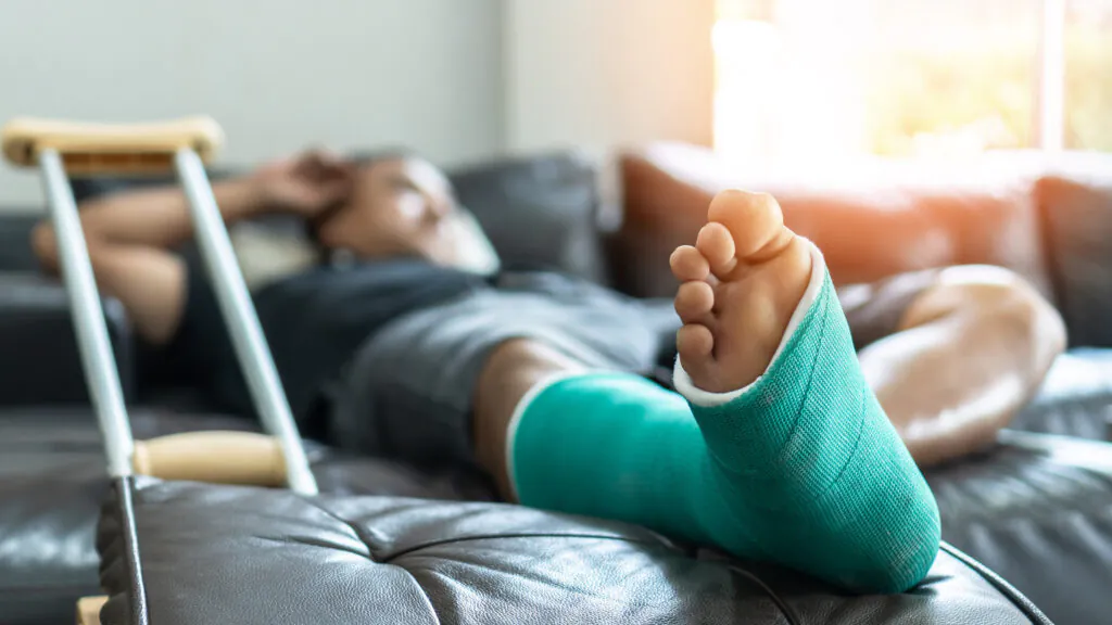 Bone fracture foot and leg on male patient with splint cast and