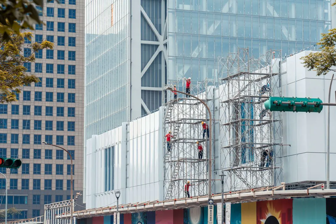 Workers on scaffolding during a city building facade job